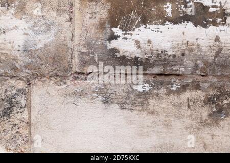 Fragment of an old stone wall with scratches and darkened. Stock Photo