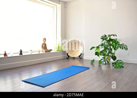 Premium Photo  Rolled up brown mat for classes in empty yoga studio