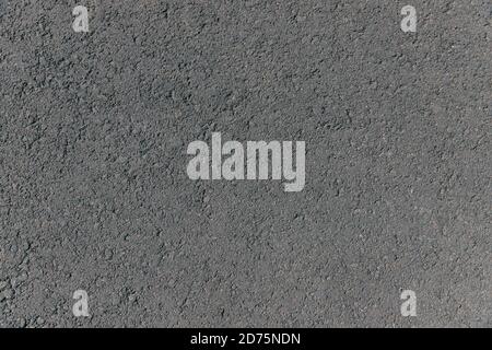 Top view of dark asphalt on the street. Texture grey asphalt background. Surface grunge rough asphalt. Car road, pavement, tile. Granular abstract uni Stock Photo