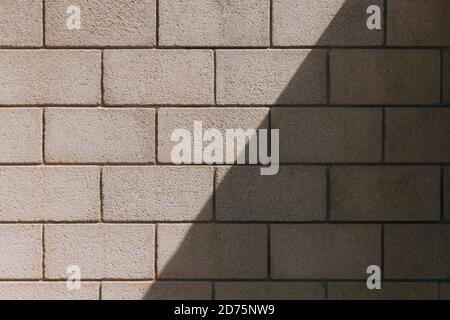 Old vintage brick wall textures for background. Yellow brown wall of Israel houses. Texture of old rock. Aged grunge concrete blocks texture. Concrete Stock Photo