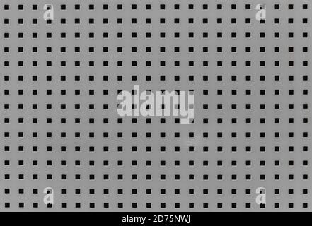 Background with many small square holes. Grey metal sheet with through square holes, textured iron. Metal grill with holes.  Close-up view Stock Photo