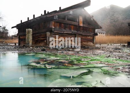 Hot springs in Japan coming out from the ground. The water is green from sulphur and the air is steamy. Stock Photo