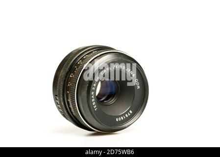 Carl Zeiss Jena DDR 50mm f2.8 Tessar lens laying on white table Stock Photo