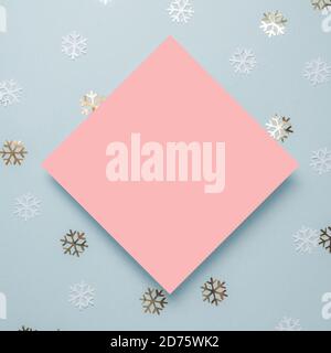 White paper card decorated with snowflakes on blue background. New Year, Christmas and winter concept. Flat lay, top view, free copy space Stock Photo