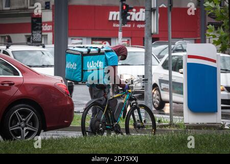 BELGRADE, SERBIA - MAY 2, 2020: Wolt logo on the bag of a delivery man on his bicycle. in belgrade. Wolt is a Finnish Food delivery app spread in Euro Stock Photo