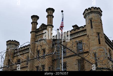 Detail of the razor wire fence and imposing facade of the historic Old Joliet Prison, which operated until 2002 and is now open for tours. Stock Photo