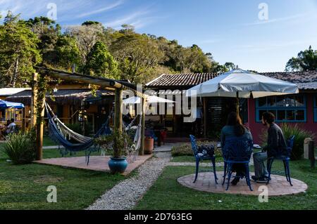 Cozy and beautifully decorated backyard garden of Moara Cafe, where costumers can relax while enjoy some coffee. Cunha, Sao Paulo - Brazil. Stock Photo