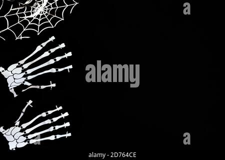Halloween decoration card with costume gloves and web for celebration design. Black background. Flat lay. Stock Photo