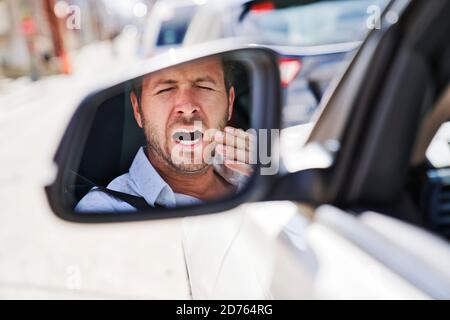 man yawn in his car because is so tired Stock Photo