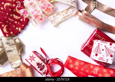 Christmas Gift Wrapping with  Red Gold White Ribbons on white background with Christmas Gifts Stock Photo