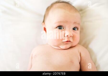 happy newborn baby on the bed on diaper Stock Photo