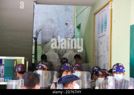 Mandalay, Myanmar. 20th Oct, 2020. U Kyaw Myint, being escorted to court by police wearing the personal protective equipment suit PPE.The United Democratic party chairman, U Kyaw Myint who was arrested for absconding, was arraigned for the third time in Chan Aye Thar Zan Township Court. Credit: SOPA Images Limited/Alamy Live News Stock Photo