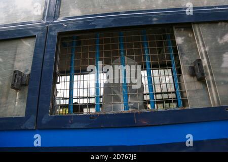 Mandalay, Myanmar. 20th Oct, 2020. A person wearing a PPE (Personal protective Equipment) sitting inside the prison car.The United Democratic party chairman, U Kyaw Myint who was arrested for absconding, was arraigned for the third time in Chan Aye Thar Zan Township Court. Credit: SOPA Images Limited/Alamy Live News Stock Photo