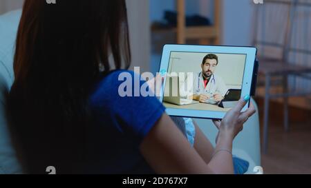 Remote patient using tablet having video conference with doctor. Stock Photo