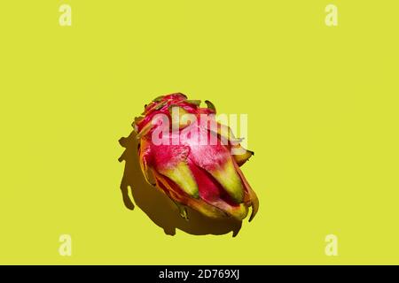 Dragon fruit - whole pitahaya on a yellow background. Stock Photo