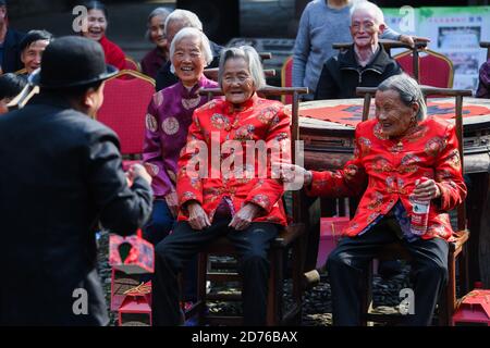 (201021) -- BEIJING, Oct. 21, 2020 (Xinhua) -- Senior residents watch a performance in Longmen ancient town of Fuyang in Hangzhou, east China's Zhejiang Province, Oct. 20, 2020. An event to greet the upcoming Senior's Day, also known as the Double Ninth Festival or the Chongyang Festival, was held in the ancient town on Tuesday. (Xinhua/Xu Yu) Stock Photo