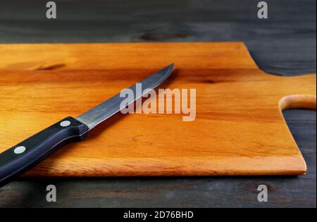 Kitchen knife isolated on a chopping board for the concept of HOME COOKING Stock Photo