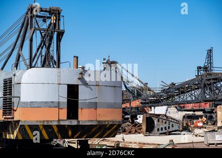 Old industrial ship boat parts in dry dock for repair, harbor of Drapetsona Piraeus Greece, blue sky, sunny day. Stock Photo