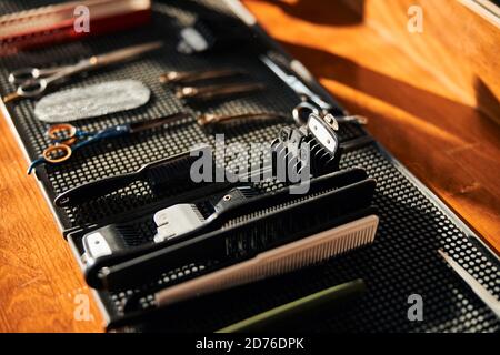 Barber scissors and combs on black rubber mat Stock Photo
