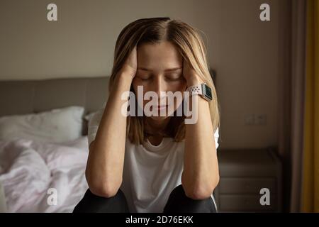 Tired Mother Suffering from experiencing postnatal depression. Health care mom motherhood stressful. Stay at home during coronavirus covid-19 pandemic Stock Photo