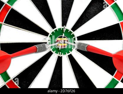 Close-up of a dart board with an imprinted flag of Uganda in the center. The concept of achieving goals. Stock Photo