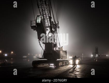 Cork City, Cork, Ireland. 21st October, 2020. Steven McCarthy of Doyle Shipping checks his crane before starting work on a foggy morning at the docks on Kennedy Quay in Cork City, Cork, Ireland. - Credit; David Creedon / Alamy Live News Stock Photo