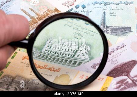 Yemeni rial in a magnifying glass Stock Photo