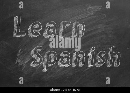 Hand drawing 'Learn Spanish' on blackboard Stock Photo