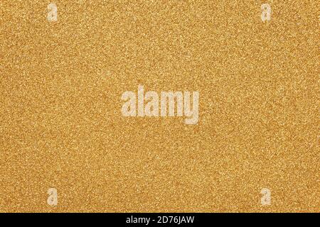 Gold sparkle texture, Christmas paper background. Glitter surface. Abstract grain pattern. Festive decoration. Shiny fabric with sequins. Holiday art Stock Photo