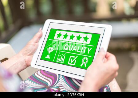 Quality concept shown on a tablet held by a woman Stock Photo