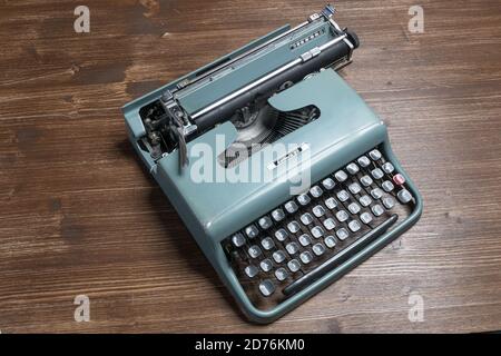 Udine, Italy. October 20, 2020. An old Olivetti typewriter, model letter 22 on a wooden table Stock Photo