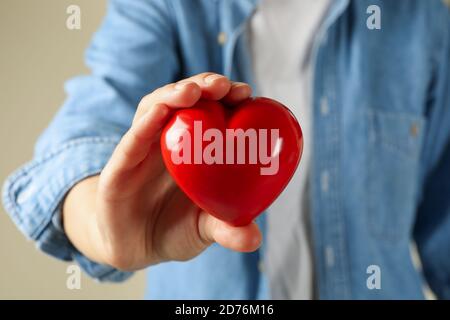 Woman in jean shirt hold red heart, close up Stock Photo