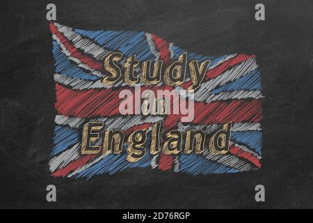 Hand drawing british flag with text 'Study in England' on blackboard. Stock Photo