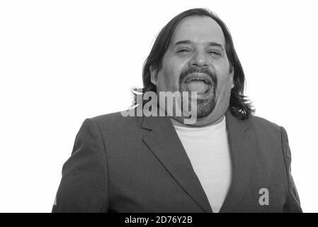 Happy fat Caucasian businessman smiling and laughing Stock Photo