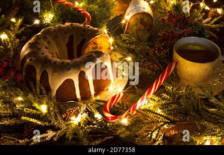 Christmas cake, tea, candy canes on a background of New Year's decor Stock Photo