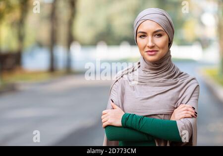 Muslim Woman Wearing Hijab And Modern Clothes Posing Standing Outdoors Stock Photo