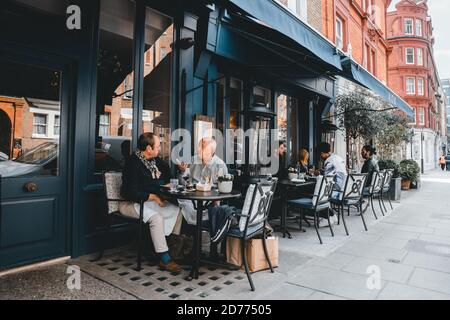 LONDON, UK-APRIL 28, 2019. Street view with restaurant terrace during lunch time in London, outdoor