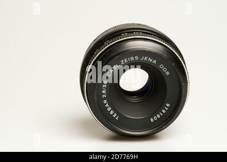 Carl Zeiss Jena DDR 50mm f2.8 Tessar lens laying on white table Stock Photo