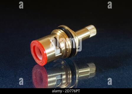 Water mixer faucet cartridge. . Detail with reflection on black background Stock Photo