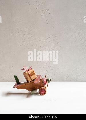 https://l450v.alamy.com/450v/2d77tda/christmas-composition-wooden-vintage-plane-carrying-christmas-gift-for-holiday-copy-space-front-view-holiday-delivery-concept-2d77tda.jpg