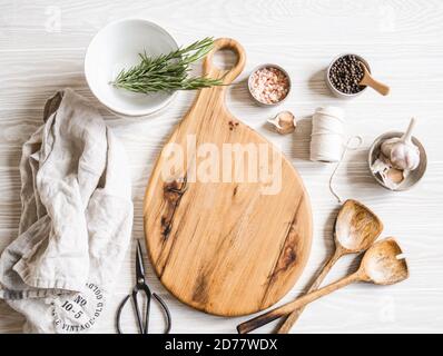 Kitchen cooking flat lay. Various ingredients, kitchen utensils and wood board for placing your text on a light background. Top view. Stock Photo
