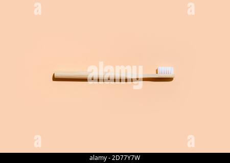 Toothbrush on camel color background. Zero Waste Home. Top view Stock Photo