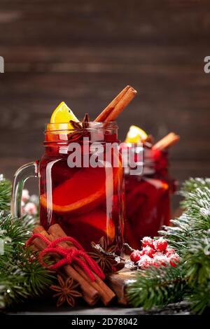 Christmas mulled wine with spices and citruses and xmas tree. With space for your greetings Stock Photo