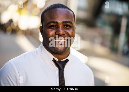 Portrait of happy african-american businessman who is looking at camera and smiling. Stock Photo