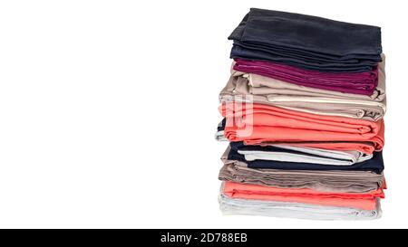 Stack of folded clean cotton plain linens on a white background. Housework and storage concept. Closeup. Copy space Stock Photo