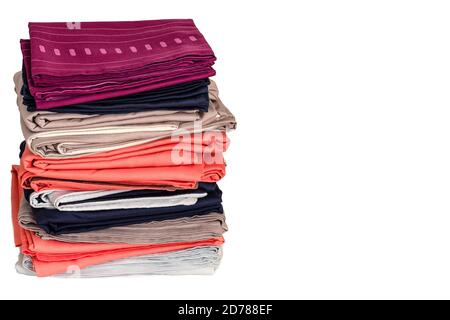 A stack of folded clean sheets and duvet covers on a white background. Bedding after washing. The concept of housework and storage. Copy space Stock Photo