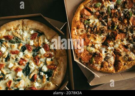 Two pizzas in boxes on table. Top view. Stock Photo