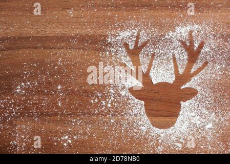 Christmas scene, reindeer head silhouette in wood and snow, copy space Stock Photo