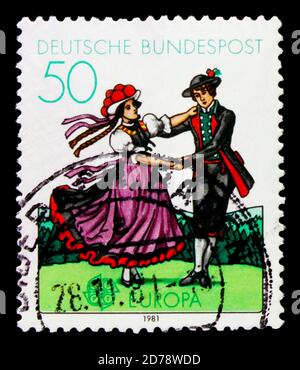 MOSCOW, RUSSIA - OCTOBER 3, 2017: A stamp printed in Germany Federal Republic shows Dansing people, C.E.P.T. - Folklore serie, circa 1981 Stock Photo