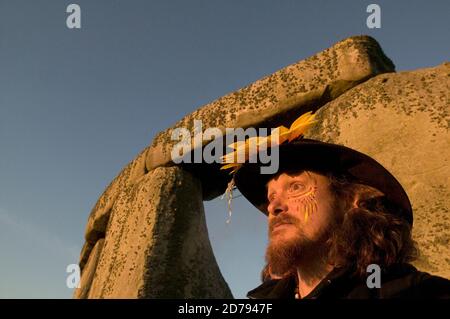 Watching and feeling the sun rise during the Summer Solstice at Stonehenge. Stock Photo